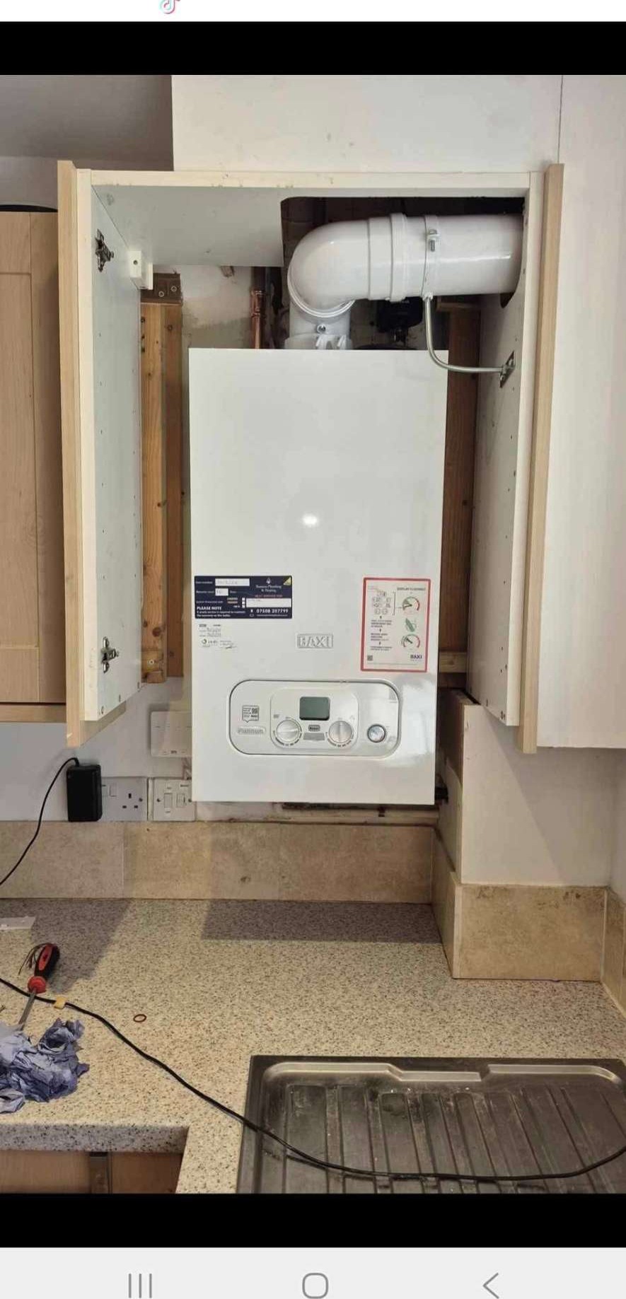 Boiler installed inside kitchen cupboard